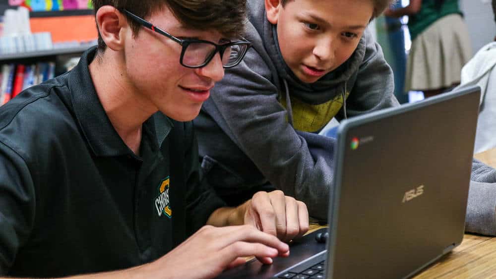 Ontario Christian Middle School Students work together on a Chromebook