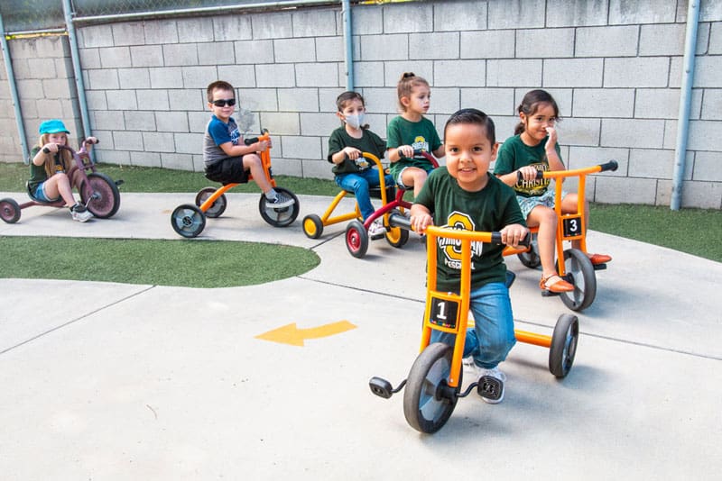 Ontario Christian Preschoolers at play on tricycles