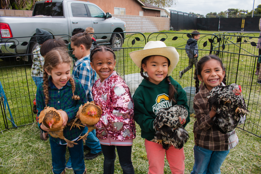 Preschool Farm Day Students holding chickens