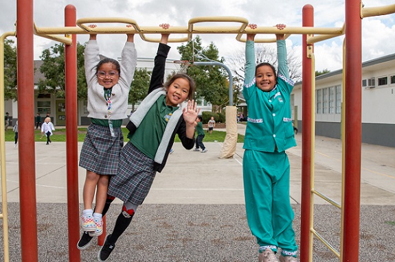 elementary students dressed for career day playing at the playground