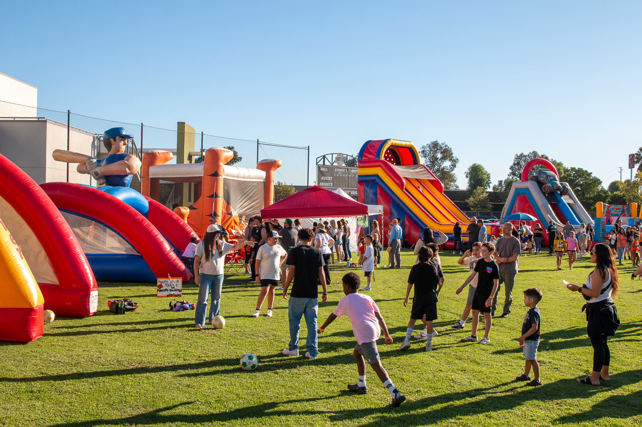 Three high school senior in their cap and gowns smiling at the crowd during the graduation ceremony.